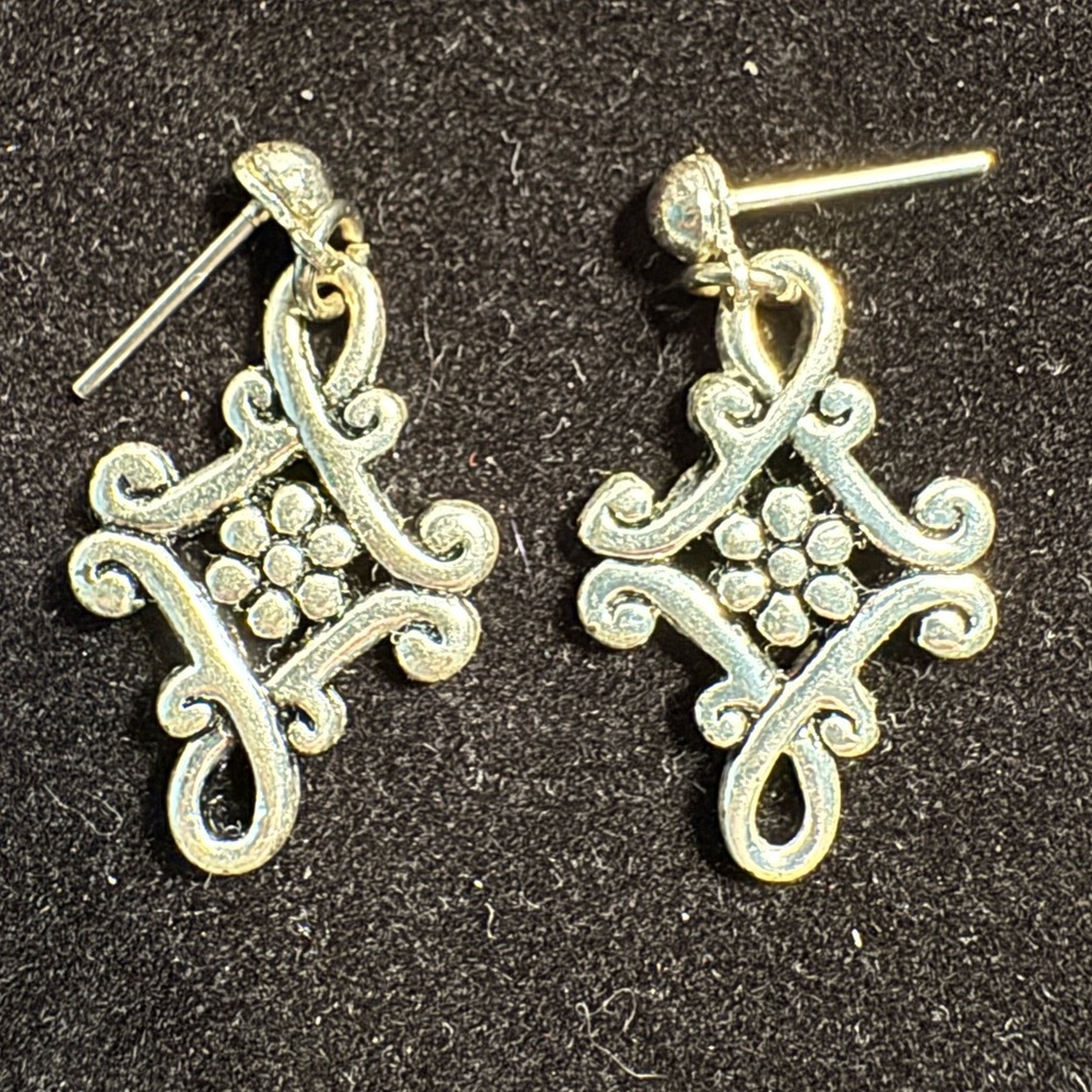 Silver-toned earrings. An intricate, symmetrical openwork Celtic Dara knot.